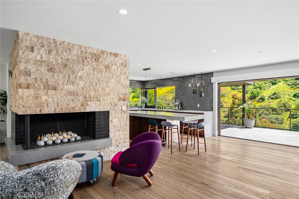 Showcasing a modern design aesthetic with exceptional architecture inside and out, this custom Laguna Beach home brings the beauty and serenity of canyon and evening-light views into fabulously open living spaces. Located on an enormous homesite of more than 53,000 square feet at the end of a cul-de-sac just moments from the vibrancy of Laguna Village, the residence reveals lush landscaping that complements stone, wood and steel exterior materials. A large glass entry door opens to a stunning interior where an organic blend of cohesive elements is embellished with on-trend decor. An abundance of natural light streams through vast windows and slide-away pocket doors, creating a seamless indoor/outdoor ambiance while illuminating approximately 5,420 square feet that includes five en-suite bedrooms and seven baths. Each level offers easy access to the outdoors, with the main floor’s dining room, fireplace-warmed living areas, and kitchen flowing to a deck to create one large and open living space. Imagine the memories created while entertaining friends and loved ones during special celebrations, all with tranquil canyon vistas as a peaceful backdrop. Custom wood cabinetry and Mont Blanc quartzite countertops capture the eye in a kitchen with oversized island, open shelving and a full tile backsplash. Top appliances include a six-burner Thermador range and a built-in refrigerator and dishwasher from Miele. A junior primary suite and an ocean-view office with deck access are also featured on this floor, giving it the feel of single-level living. Follow a dramatic floating staircase to the second floor, which hosts a family room, secondary suites and the primary suite. For the ultimate in personal luxury, this grand suite is refined with generous proportions. Opening to the deck, the suite hosts a fireplace and a walk-in closet with custom built-ins. The primary bath is infused with the feel of a five-star resort, complete with freestanding tub, oversized shower, two sinks and gorgeous stone finishes. The lowest level is primed for entertaining with a game/media room, fireplace, wet bar, 378-bottle wine cellar, guest suite, and a towering two-story wall of glass. Solar power, a standing-seam metal roof, and an attached two-car garage are joined by ample guest parking. Minutes to the sand, top-rated schools, galleries, restaurants and trails, this showplace captures the unique energy of Laguna Beach in one special place that you will be proud to call home. Showcasing a modern design aesthetic with exceptional architecture inside and out, this custom Laguna Beach home brings the beauty and serenity of canyon and evening-light views into fabulously open living spaces. Located on an enormous homesite of more than 53,000 square feet at the end of a cul-de-sac just moments from the vibrancy of Laguna Village, the residence reveals lush landscaping that complements stone, wood and steel exterior materials. A large glass entry door opens to a stunning interior where an organic blend of cohesive elements is embellished with on-trend decor. An abundance of natural light streams through vast windows and slide-away pocket doors, creating a seamless indoor/outdoor ambiance while illuminating approximately 5,420 square feet that includes five en-suite bedrooms and seven baths. Each level offers easy access to the outdoors, with the main floor’s dining room, fireplace-warmed living areas, and kitchen flowing to a deck to create one large and open living space. Imagine the memories created while entertaining friends and loved ones during special celebrations, all with tranquil canyon vistas as a peaceful backdrop. Custom wood cabinetry and Mont Blanc quartzite countertops capture the eye in a kitchen with oversized island, open shelving and a full tile backsplash. Top appliances include a six-burner Thermador range and a built-in refrigerator and dishwasher from Miele. A junior primary suite and an ocean-view office with deck access are also featured on this floor, giving it the feel of single-level living. Follow a dramatic floating staircase to the second floor, which hosts a family room, secondary suites and the primary suite. For the ultimate in personal luxury, this grand suite is refined with generous proportions. Opening to the deck, the suite hosts a fireplace and a walk-in closet with custom built-ins. The primary bath is infused with the feel of a five-star resort, complete with freestanding tub, oversized shower, two sinks and gorgeous stone finishes. The lowest level is primed for entertaining with a game/media room, fireplace, wet bar, 378-bottle wine cellar, guest suite, and a towering two-story wall of glass. Solar power, a standing-seam metal roof, and an attached two-car garage are joined by ample guest parking. Minutes to the sand, top-rated schools, galleries, restaurants and trails, this showplace captures the unique energy of Laguna Beach in one special place that you will be proud to call home.