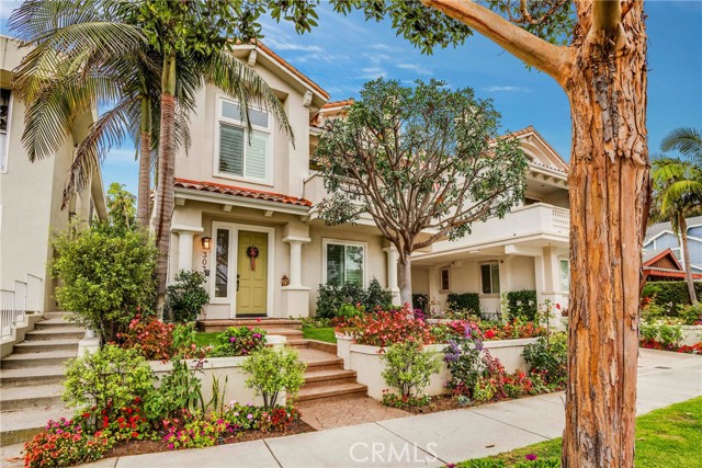 Manicured front lawn edged with colorful flowers