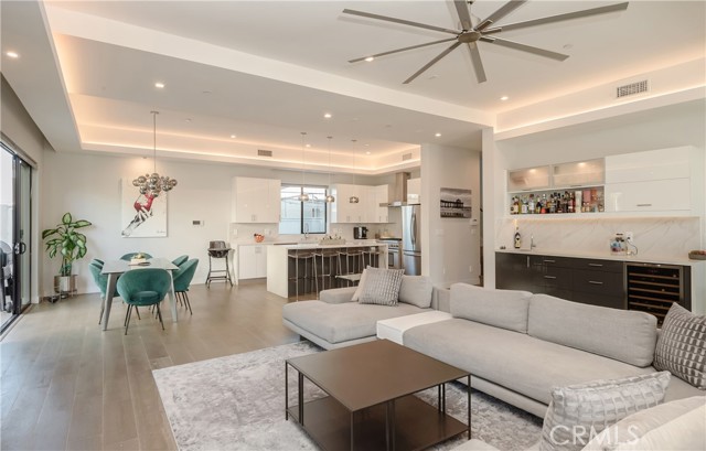 Open living, dining and kitchen area with wet bar