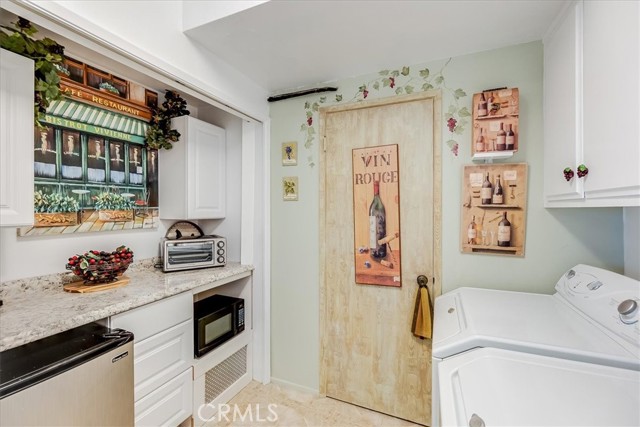 Bottom floor laundry & kitchenette has a refrigerated wine cellar