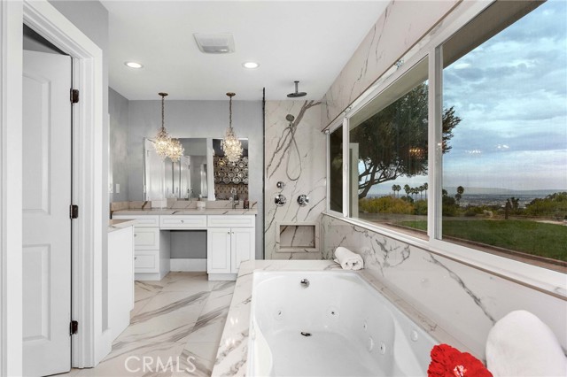 The master bathroom offers sweeping views .