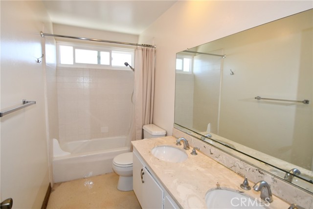 Full hallway bathroom with double sink vanity