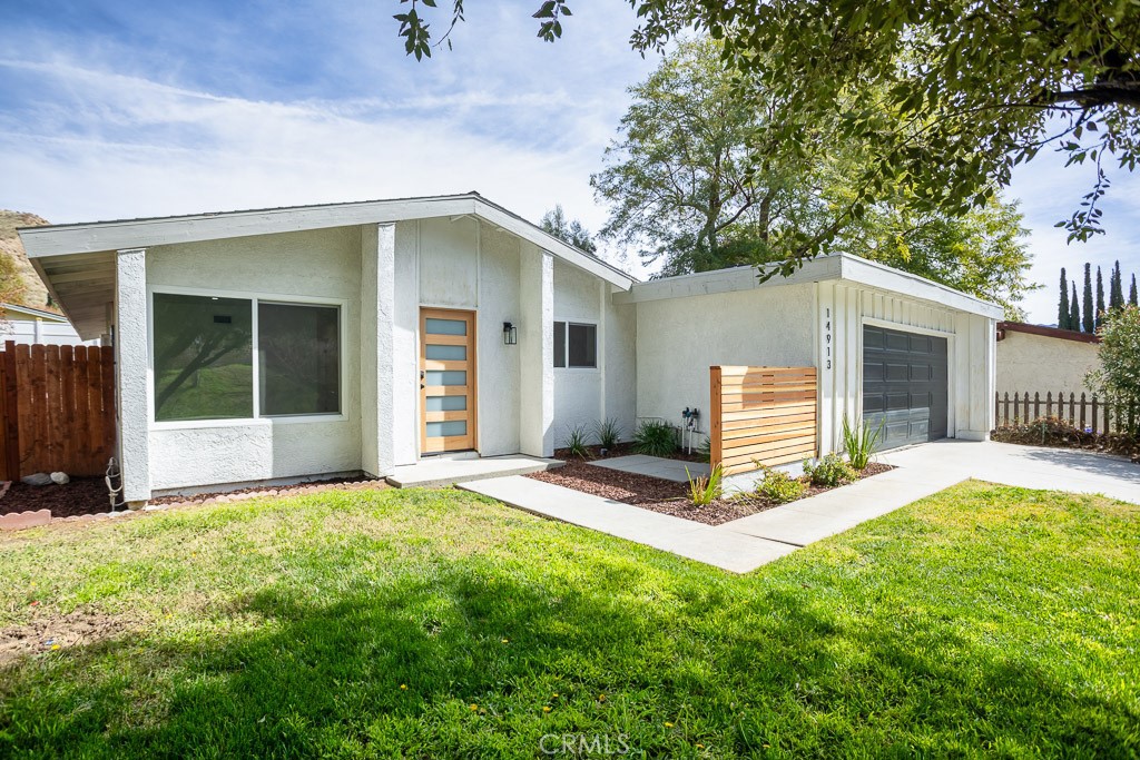 Welcome home and discover this lovely residence located in a highly sought after neighborhood of Canyon Country.  This charming residence has been recently updated, offering modern amenities and a warm, inviting atmosphere.  As you step inside you’ll discover a sunlit haven with tons of natural light beaming through the brand NEW dual pane windows! Recently renovated kitchen boasting a beautiful mixture of designer cabinets with white shaker on top and a light wood panel for the base offer ample storage. New calcutta quartz countertops accented with argos ceramic full backsplash tile adds a perfect blend.  Additionally kitchen features new recess lighting, new sink with faucet, new electrical outlets and new stainless steel appliances that include a new refrigerator.  Adjacent to the kitchen is the dining area.  Brand new vinyl flooring throughout including both bedrooms.   Both bathrooms have been nicely updated with new toilets, new tile flooring, new plumbing fixtures, new mirrors and new lighting. The primary bathroom offers a stand up shower displaying brand new designer tile and new glass door.  Other upgrades include brand NEW HVAC system just installed, new baseboards throughout, new interior paint, new light fixtures, new outlets, and new ceiling fans in all the bedrooms.  Exterior features a good size lot! Long driveway with plenty of room for your vehicles and potentially an RV.  Large pool size backyard with endless possibilities to make it your own dream oasis!  Conveniently located near town amenities including a new shopping center, award winning schools, parks, and commuter friendly.  Whether you're looking for a starter home or a comfortable space to settle down, this property provides the perfect blend of comfort and style. Don't miss the opportunity to make this beautiful house your new home!