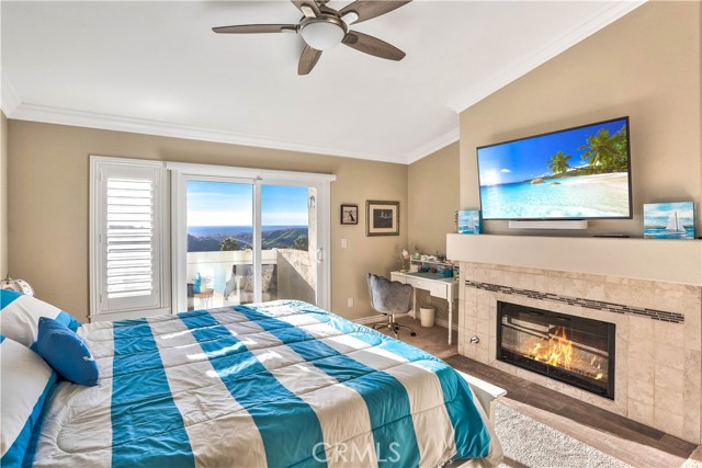 The master bedroom has ocean, Catalina Island and harbor views. There's also a gas fireplace, private balcony and ceiling fan.