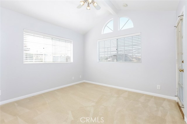 North West bedroom w/deck access, vaulted ceiling w/fan