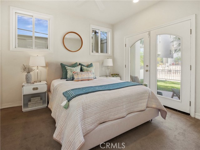bedroom 3 with private bath and private french doors overlooking grassy yard