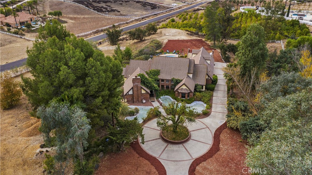 42200 Calle Barbona Temecula, California Fly Home! This is a unique opportunity to own this beautiful Temecula Wine Country EQUESTRIAN and PRIVATE AIRSTRIP estate with expansive VIEWS. Enter your own impressive gate to the private entry and beautiful Tudor style home. The property is 5.25 acres of distinction with stunning 4,491 sq.ft. home, direct access to the private community landing strip, spotless 5,000 sq.ft. barn, mini dressage arena, 2 stall mare motel, floating pool, and jacuzzi. Inside is gorgeous too with 6 over-sized bedrooms, 2 sitting rooms, 2 decks, remodeled kitchen, upgraded flooring, and views from every window. Live in Wine Country and still be just 5 minutes to schools, shopping, and freeways. Be sure to look at the 360 video tour to see every detail of the home. Click on the VT icon or go to https://view.ricohtours.com/db948674-1734-45fe-bf39-5120125ffb16.