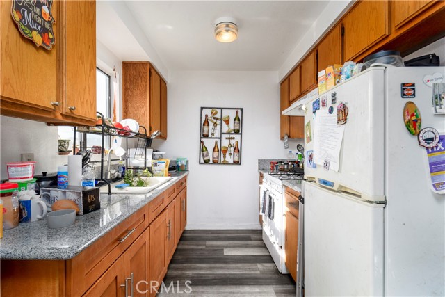 kitchen with granite counters, new floor, gas stove and range.