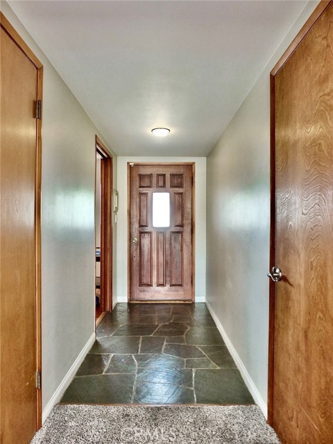 View of slate entry and front door from living room