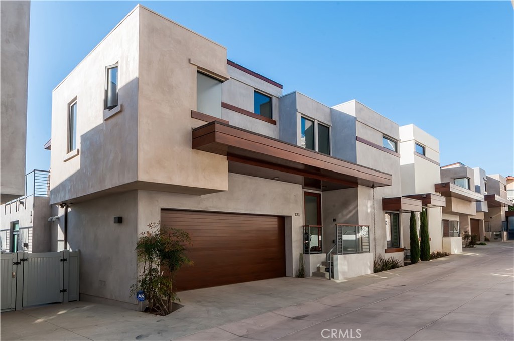 Beautiful, coastal contemporary, townhome with over 2,500 sq ft. of living space. A stunning living area with doors that open to a huge deck, almost 1000 sq feet, with stunning ocean views from Catalina to Malibu. Extra large kitchen with stylish finishes, marble counter tops and large pantry. The 3 bedrooms are all located on the lower level along with an additional living area that opens up to the grassy backyard. The Master suite is spacious and relaxing with tall ceilings and a large master bath, beautifully styled with a clean, classic look. Within quick distance to all the great restaurants and shopping in downtown Hermosa Beach, the nearby school, parks and of course, the beach. You'll feel like you're on vacation everyday living in this beautiful home watching the sunsets and colorful evening skies.