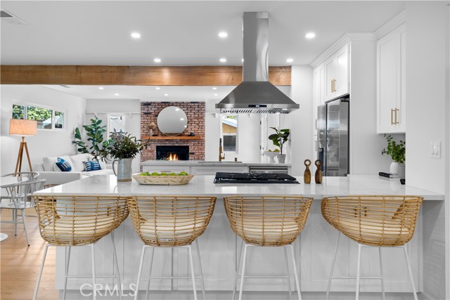 Kitchen island number one for guests or famlit to sit at while you are on the stove.