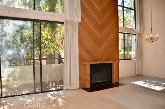 Open Floor Plan with Cathedral Ceilings, two story fireplace and a wall of windows. Direct access out to a private patio.