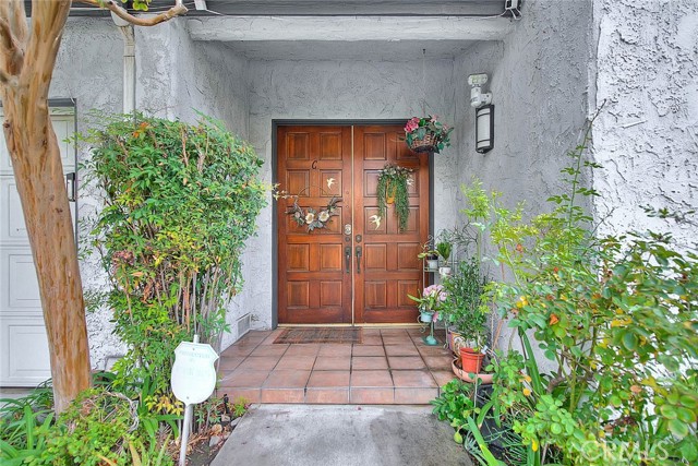 Double Door Entry Surrounded By Welcoming Shrubs