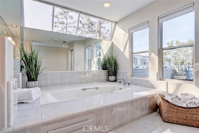 Master suite soaking tub surround be high windows and private 2nd deck