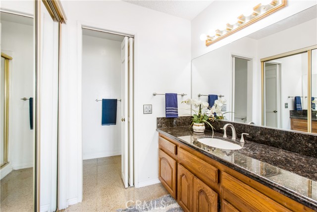 Primary bath has granite countertop and a shower
