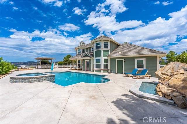 Front of the home with pool, spa and fountain