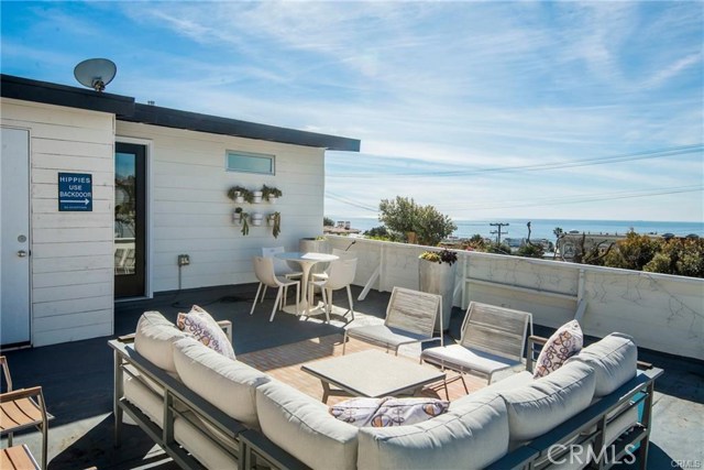 703 Longfellow Avenue Hermosa Beach, California Home with income! It may be possible to add another bedroom or more to the upper unit (Check with the City of Hermosa Breach). Step inside this duplex and discover the laid back beachy lifestyle you deserve. Ideally located on a desirable residential street next to Manhattan Beach Hill Section, Cool and classic 1950s cottage has been lovingly updated. Savor OCEAN VIEWS from the elevated hardscaped patio featuring a gas fire pit surrounded by a delightful garden. Inside, two fresh, cheery, spacious one-bedroom units offer rental income opportunities/creative living solutions for family/friends. Make yourself at home in the charming upstairs space, which offers a hip retro vibe complete with a BERTAZZONI range, a vintage-inspired GE refrigerator, an island with dishwasher and microwave, a Dutch-door, a bathroom skylight, a washer/dryer and a large deck with MORE expansive OCEAN VIEWS! Downstairs, the second one-bedroom unit features a full kitchen, washer/dryer, large closets, modern flooring, and an open-living space overlooking bougainvillea and citrus trees. Park two cars in your garage plus two more in the driveway. Better yet, WALK or BIKE to the Strand, Downtown Manhattan Beach, Hermosa Beach, Lazy Acres, Gelson’s and the leafy Green Belt. This pleasant hilltop perch is convenient and peaceful. Easy to get to, yet tucked away from power plants, parking lots and busy street noise. This unique gem is hard to come by here in the beach cities. Come see for yourself.