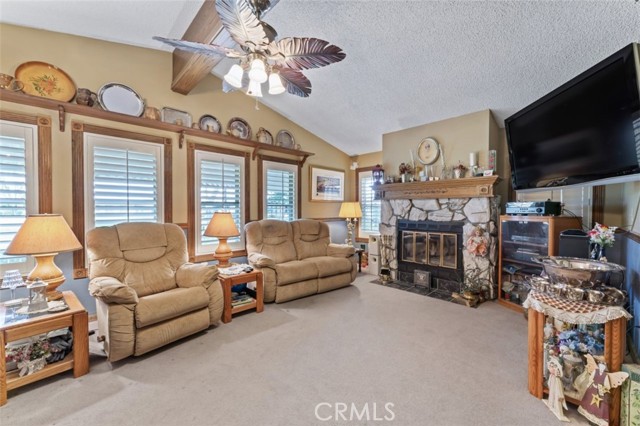 Family room w fireplace, vaulted ceilings and ceiling fan/light fixture