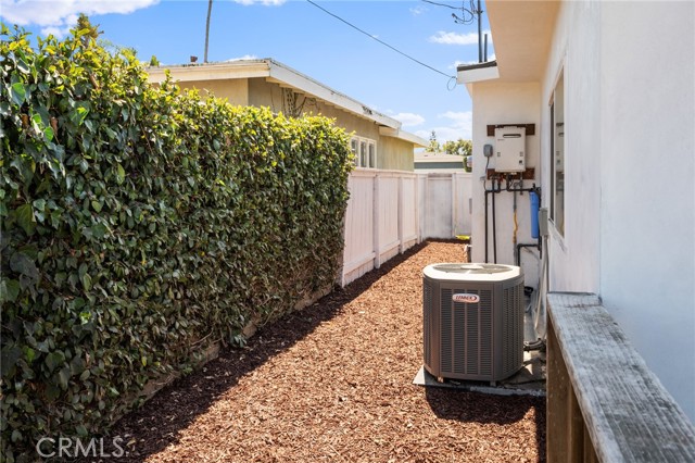 New wood chipped side of house with AC unit.