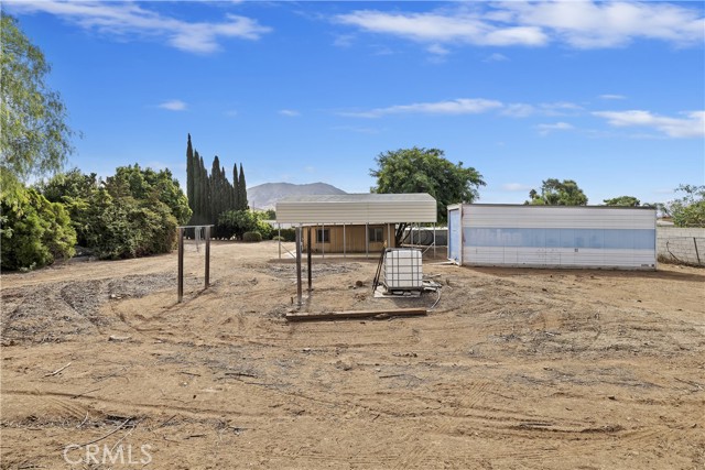 View of backyard with fresh water container for multiple use.