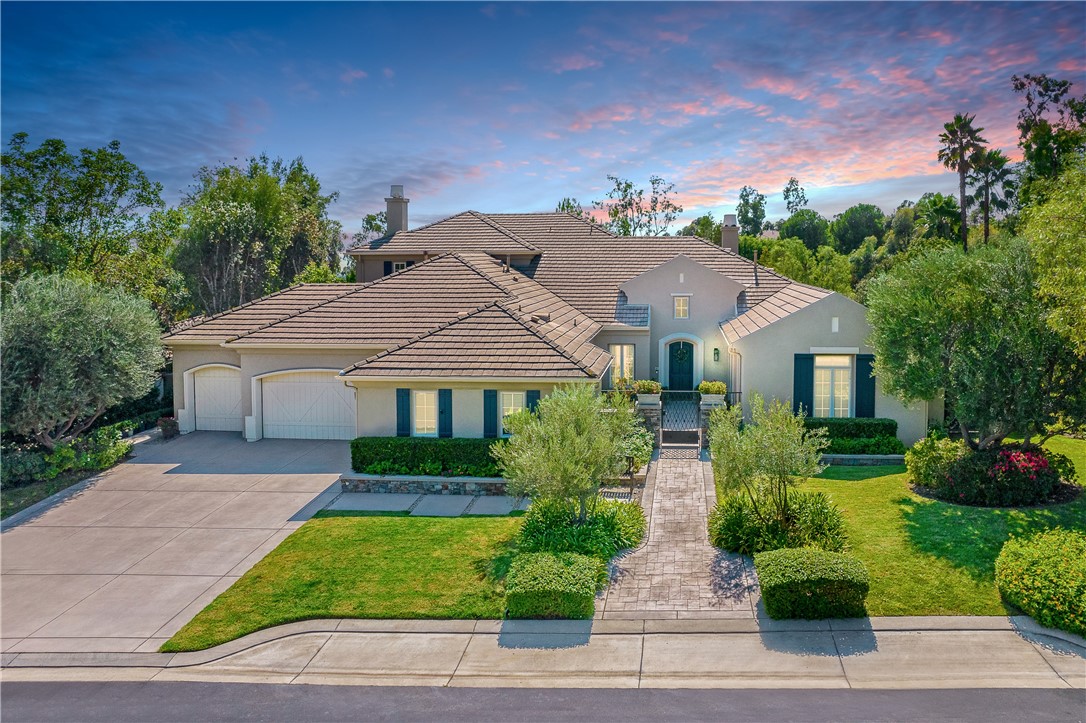 Situated on an impressive corner view lot with immense privacy. The Tustin Ranch Estate home was completely remodeled between 2018-2021. Located behind 24-hour guarded gates, truly amazing grounds with gorgeous landscaping in the community. Breathtaking views of the rolling hills and city lights. Built by renowned Standard Pacific with approximately 5,121 sqft of living space on an over 17,000 sqft lot. This elegantly designed 5-bedroom home is the perfect home for large-scale entertaining. Step into the light-infused foyer with 14+ feet height ceiling. Wood plank-like tile flooring flows through the airy first level featuring custom lighting, built-in shelving, elegant French doors, and custom shades & drapes. A gallery that connects all the main living areas. BRAND NEW interior paint, & carpet. BRAND NEW triple zone HVAC system (both condensers and furnaces). Custom audio & visual system (2021). Chef’s kitchen has two-toned custom cabinets, quartz countertops, farmhouse sink, oversized island, Sub-zero built-in fridge, WOLF double oven, 6-burner gas stove + griddle, wine fridge, 2 sinks, custom floating shelves, designer hardware/fixtures & timeless subway tile full backsplash. MAIN LEVEL MASTER BEDROOM + 3 more bedrooms on the main level. 2nd level has an oversized loft + junior master w/a balcony. 5 beds (4 en-suite beds) and 4.5 baths. It was originally a SINGLE LEVEL floor plan with the builder upgraded second-floor guest bedroom and loft. Master bedroom has a fireplace and French doors that lead to the backyard. Master bathroom was remodeled in 2021 with full splash marble vanity wall, herringbone flooring, Italian porcelain shower, jetted tub, double chandeliers, vanity area, custom shaker-style cabinets, quartz counters, and designer fixtures/faucets. The powder room has custom wainscoting wall panel, hexagon marble vanity wall, marble sink & designer fixtures. The backyard was completely redone in 2018-2019 w/ the installation of the new pool/spa, an oversized pavilion, multiple seating areas, a bocce ball court, low-maintenance artificial grass, and lush landscaping. Outdoor kitchen has built-in Twin Eagles fridge & ice makers, Hastan gas grill, heater, 2 fans & a fireplace. It offers an abundance of parking, along w/ 4-car oversized garage. FULLY PAID solar panels. Tuck between Peters Canyon and Tustin Ranch Golf Course near The Market Place. Highly acclaimed Tustin Ranch schools, elementary, and middle schools are within close proximity.