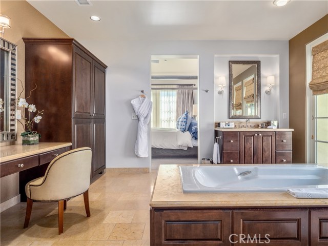 The airy master bathroom features two vanity areas, an oversize soaking tub, roomy shower plus a separate vanity/makeup area