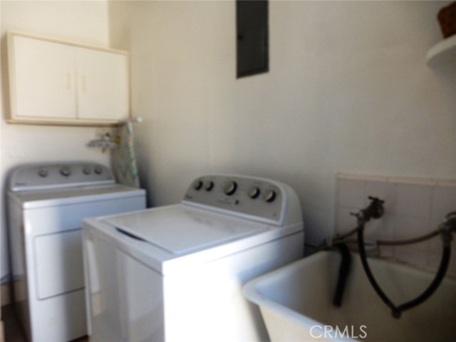 Laundry area just off of the side door and just before the kitchen.