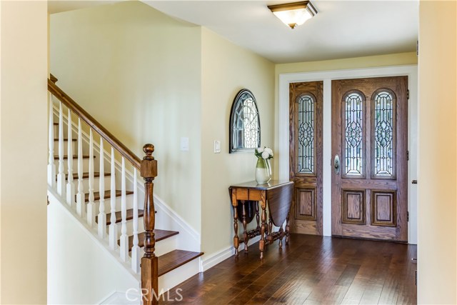 Entry with leaded glass door and side light, new hardwood flooring and new wood banister.