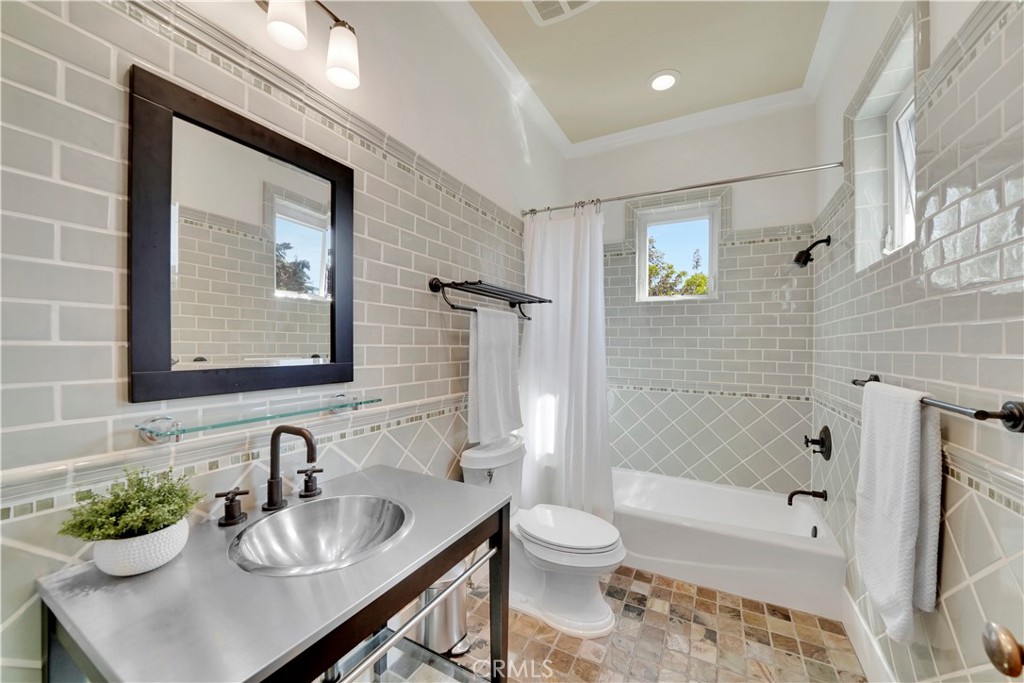 bathroom with custom tile in secondary bedroom