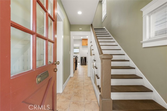 Inviting entryway, freshly painted with period finishes. Beautiful staircase and moldings around windows.