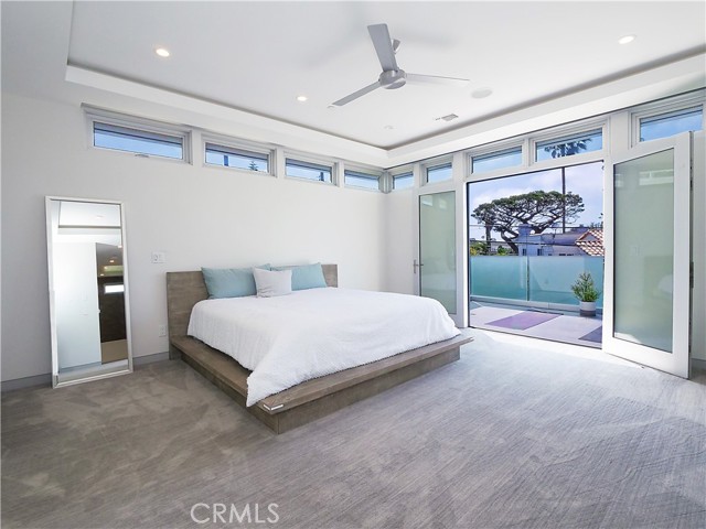 Master bedroom with built-in storage and his and her closets.