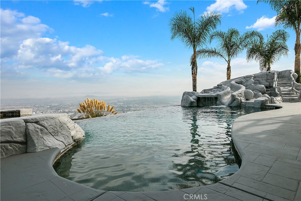 28190 Sycamore Mesa Road Temecula, California Escape city life with this lovely Farmhouse estate in the heart of wine country. This 5-acre home offers scenic views from every room. Its charming wrap-around balcony, Infinity-edge pool and sunroom create the ultimate getaway for your busy lifestyle. With over 5800 sq. ft of living, this retreat offers 6 bedrooms and 7 baths. Each aspect of this home was designed to be ideal for the out-of-town owner. No expense has been spared on this luxury estate; from the heated floors, digital fireplace, water purification and UV protection system. Enjoy gourmet kitchen featuring Bosch refrigerator, stainless appliances, under cabinet lighting, television, wet bar, walk-in pantry, sunroom, custom lighting, intercom, downstairs retreat, downstairs bedroom and en suite bath, media room, fireplace and butler pantry. Upstairs enjoy a large owners suite with private balcony, spa and outdoor fireplace. Owner’s suite has a walk in shower, double pedestal sinks, his and her closets, and attached retreat/library. In addition to upstairs laundry room, enjoy 4 guest bedrooms with en suite baths along with Media room at the halls end. This home features state of the art surveillance system that can be remotely monitored along with a paid solar system. Interested in going off the grid? This makes the perfect getaway. Home has excellent Internet connectivity. Only minutes to Old Town Temecula, wine country and freeway access. Take the 3D tour at https://my.matterport.com/show/?m=jkxwxzBwpCq&brand=0