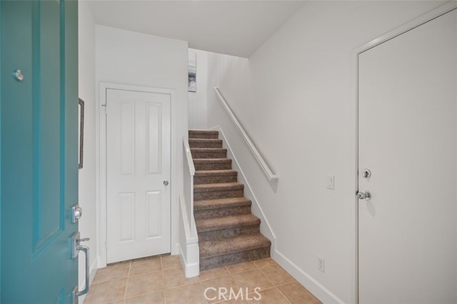 Ground-level entrance with direct access to 2-car garage and stairs to main living level.