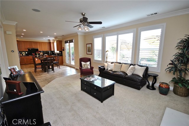 Kitchen Opens to Large Family Room with Ceiling Fan