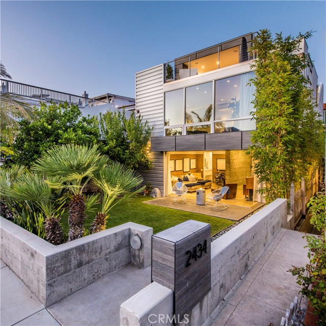 2434 Manhattan Avenue Hermosa Beach, California A spectacular ground-up custom build in one of the best locations in all of Hermosa Beach, this premier ocean view home sets the bar for contemporary living & sustainability with an elegant aesthetic. The homes exquisite attention to detail & meticulous planning perfectly captures the essence of beach living w/ entertaining in mind. 1 of only 2 LEED certified homes in Hermosa Beach, this home is truly one w/ the environment. Designed as a 4 bedroom with over 4,100sf the homes effortless flow incorporates open spaces, high-ceilings w/ an emphasis on natural light throughout while focusing on the homes captivating ocean & sunset views. Framed in floor to ceiling walls of glass & disappearing sliding glass doors, the homes spacious first floor living room opens to a private front yard w/ mature trees creating a serene indoor/outdoor flow. The lower level is host to an in-home gym, library & large bonus room. An all-glass floating staircase leads you to the upper levels w/ a gourmet Arclinea custom kitchen featuring a wall of Miele appliances & a sleek, clean aesthetic that effortlessly joins the main living area & expansive view deck. Perfectly illuminated by the California sun from sunrise to sunset, the home exudes a cool sophistication that highlights the multiple outdoor spaces, including private rooftop deck w/ stunning panoramic ocean & coastline views from PV to Malibu. Sophisticated, sustainable living in an a powerful and highly sought after location in North Hermosa.
