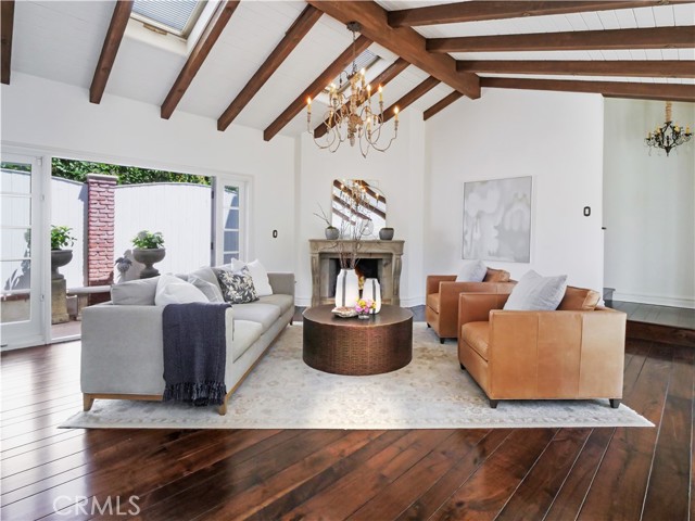 Living Room with vaulted ceiling, French doors, antique stone fireplace, walnut hardwood floors