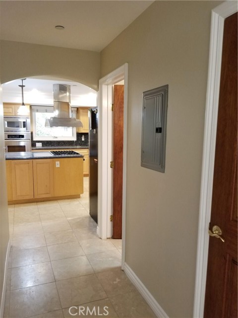 Hallway to kitchen with powder bath and coat closet