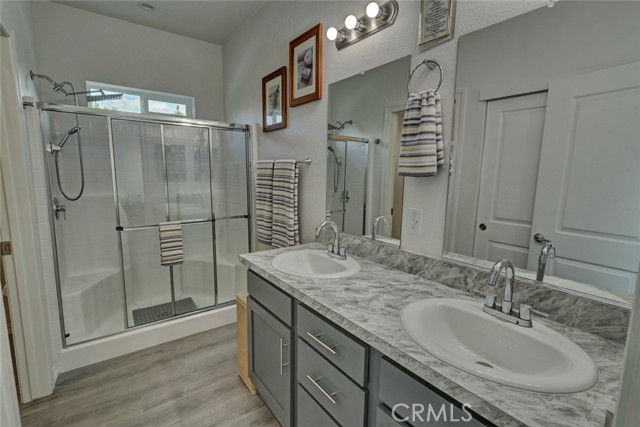 MASTER BATH FEATURES A WALK-IN SHOWER, DUAL SINK VANITY, DOUBLE CLOSET AND PRIVATE TOILET AREA