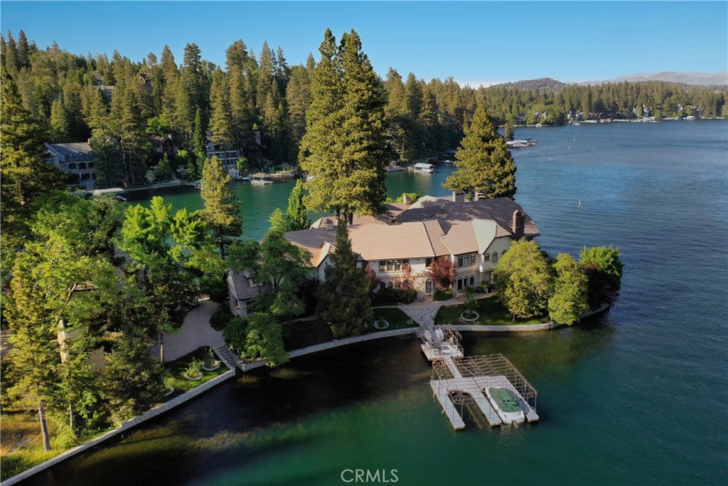 Welcome to Lake Arrowhead's Preeminent Waterfront Estate!It is situated on it's own Private Peninsula, featuring over 675 feet of shoreline, with a double boat dock and extensive outdoor entertaining areas.Upon private entry, you will experience the one and only property of this magnitude in Lake Arrowhead. A stunning foyer, massive ceilings, expansive windows and custom lighting all perfectly showcase the amazing lake and ridge line views, from virtually every room. This custom Paradise was tastefully updated and accented with shimmering walls of stack stone quartz, top to bottom. Extensive improvements include new custom bathrooms, fixtures and flooring, a glorious gourmet kitchen with impressive walk-in butler pantry and, adjacent to formal dining, a temperature controlled double-door wine cabinet.There are simply so many five star amenities, that it’s impossible to mention them all! Some of them are an elevator, an ice cream bar parlor, a gentlemen's bar, a spa, sauna, private office and recreation rooms with even two indoor private puppy suites! And, a fully self-contained Guest Home with 3 garages is conveniently located on the property.This regal and well appointed home has it all, and it sits gracefully on this beautiful LEVEL peninsula! A picture is worth a 1000 words, so feast your eyes on these! This once-in-a-lifetime, iconic Lake Arrowhead home is listed for $15,500,000. A detailed and additional amenities list is available upon request.