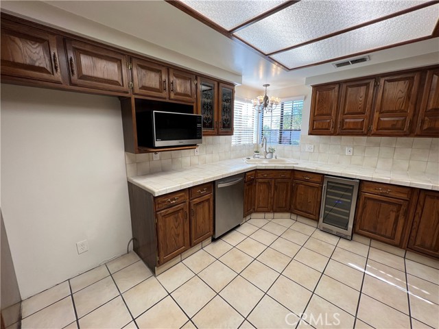 Refrigerator location - dish washer and microwave.