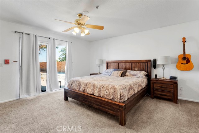 Primary bedroom with Patio Slider leading to backyard.
