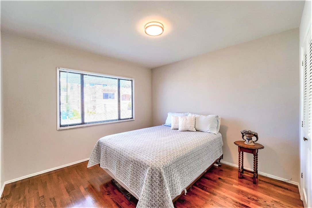 The second bedroom at the front of the home has hardwood floors and a sunny bright exposure.