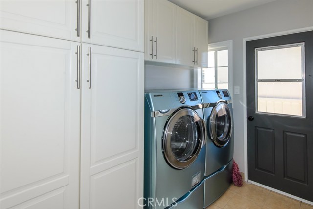 Washer and dryer will remain in the spacious laundry room with custom cabinets!