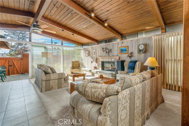 Perspective of the living room with tile floors and a decorative fire place