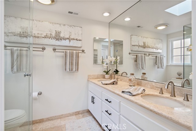 Remodeled main bath with new faucets, skylight and stone counter