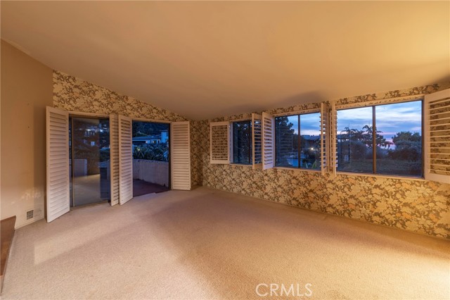 Primary bedroom with a walk in closet, bathroom and ocean views