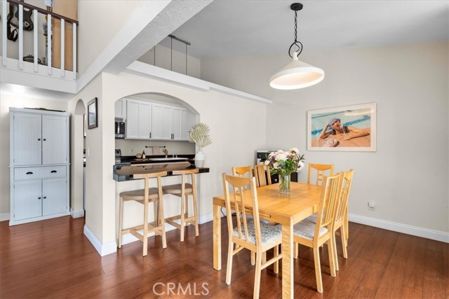 Dining room leads to kitchen with breakfast bar