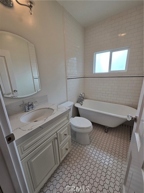 The guest bathroom has a clawfoot tub and gorgeous tile.
