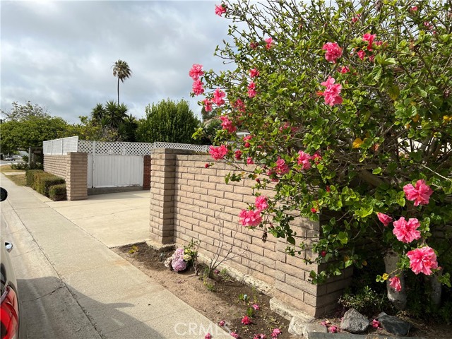 DRIVEWAY TO THE GARAGE W/BRICK WALLS SECURING THE PROPERTY