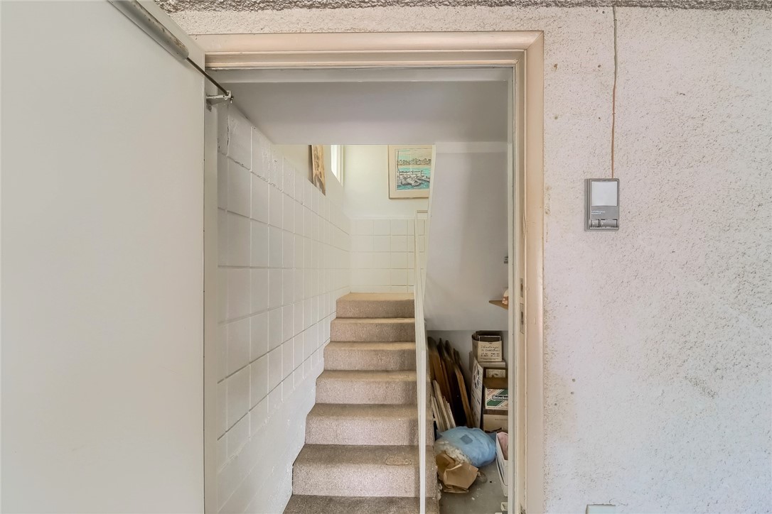 The Stairway from the Garage to the House has a Storage Area with Shelving.